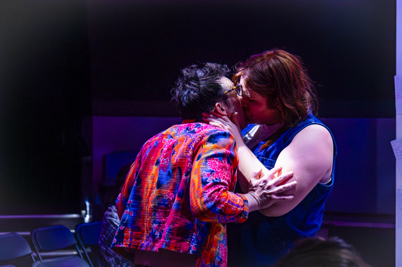 Two actors embracing on stage during production at Play bar with 3 Witches Shakespeare in Louisville Kentucky